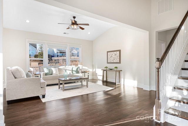 living area featuring stairway, wood finished floors, visible vents, and baseboards