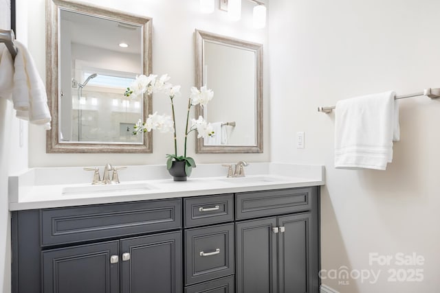 full bath with double vanity, a shower, and a sink