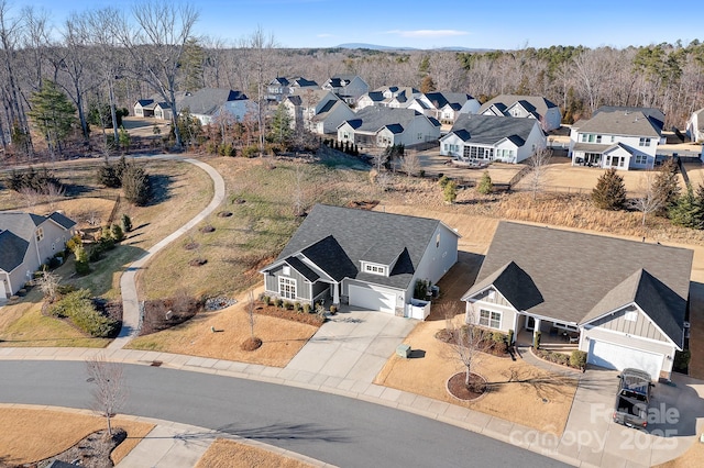 drone / aerial view with a residential view and a forest view