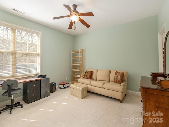 interior space featuring baseboards, visible vents, ceiling fan, and carpet flooring