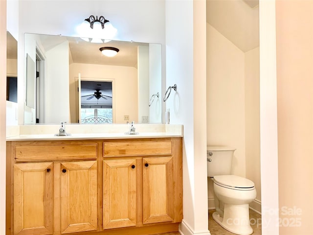 ensuite bathroom featuring double vanity, connected bathroom, toilet, and a sink