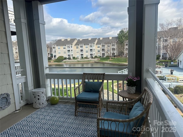 balcony with a water view and a residential view