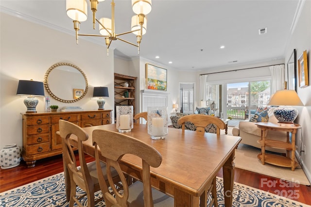 dining room featuring crown molding, recessed lighting, dark wood-style floors, visible vents, and a notable chandelier