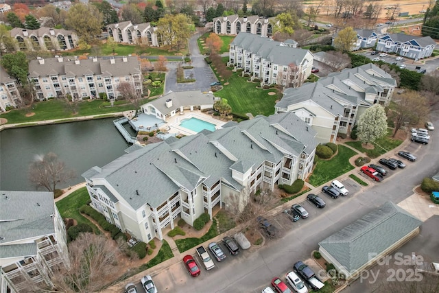 bird's eye view featuring a residential view and a water view