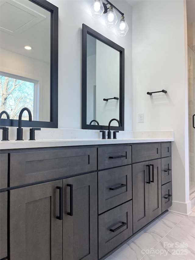 bathroom featuring double vanity, marble finish floor, a shower stall, and baseboards