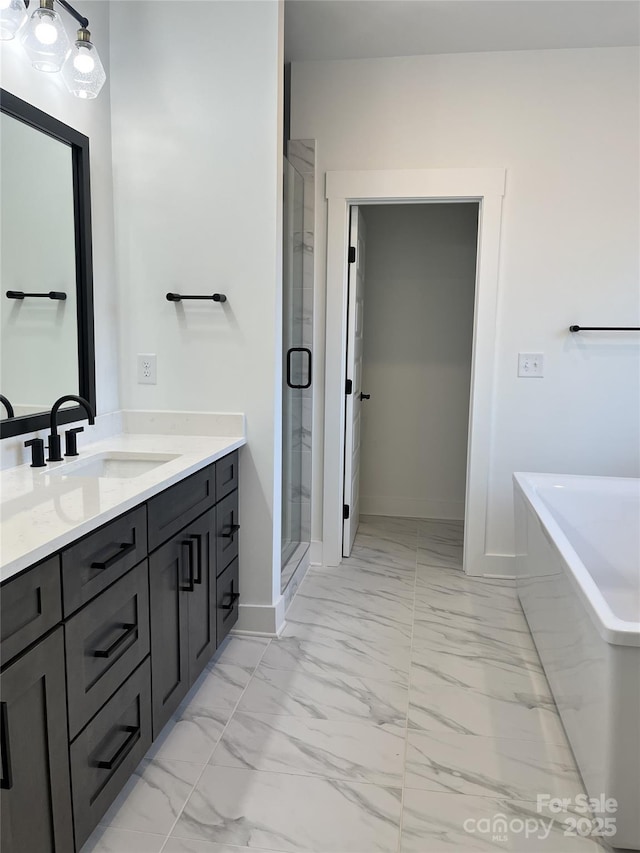 full bathroom with baseboards, marble finish floor, a freestanding bath, vanity, and a shower stall