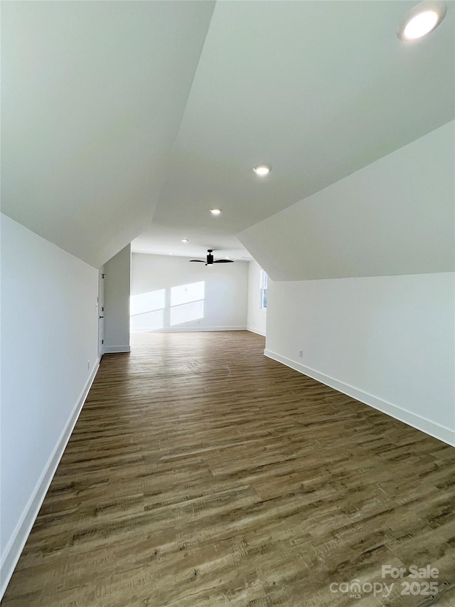 additional living space featuring lofted ceiling, recessed lighting, a ceiling fan, wood finished floors, and baseboards