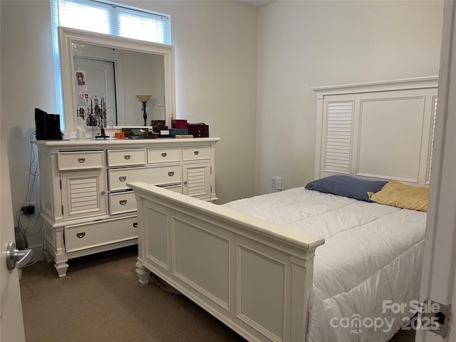 bedroom with dark carpet