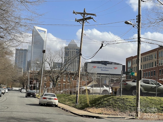 view of street featuring street lights, curbs, and sidewalks