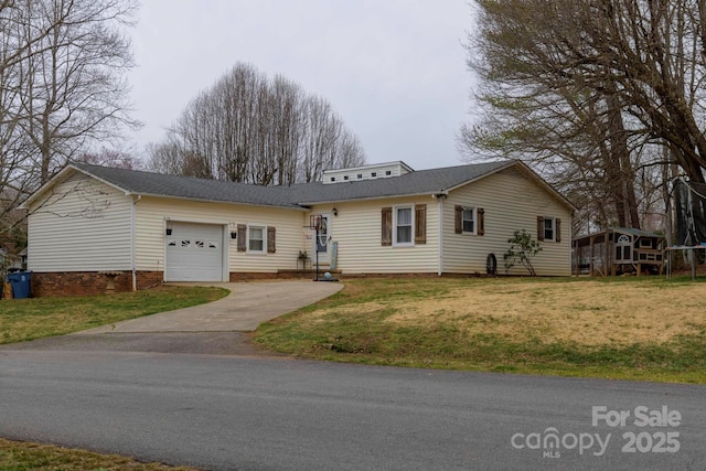 view of front of house with an attached garage and a front yard