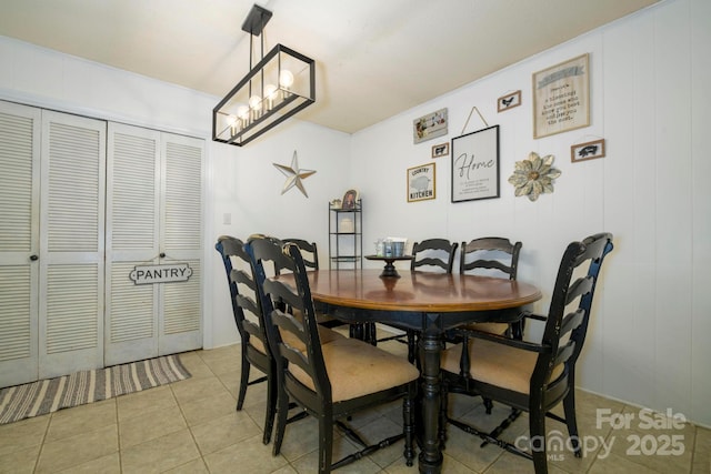 dining room featuring a notable chandelier and light tile patterned floors