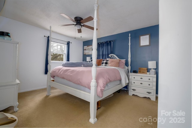 bedroom with a ceiling fan, carpet flooring, and baseboards