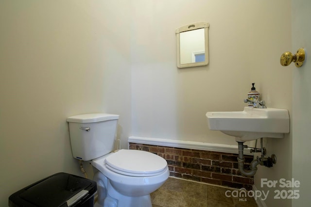 bathroom featuring tile patterned flooring and toilet