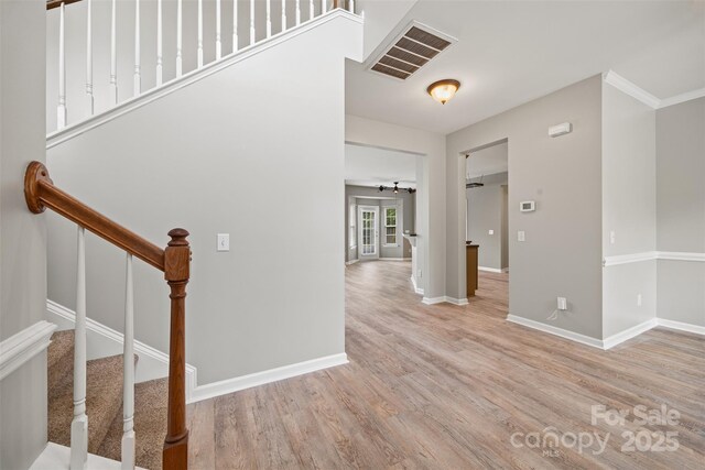 entrance foyer with wood finished floors, baseboards, and stairs