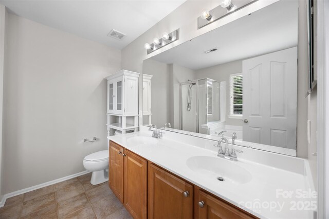 full bathroom with a stall shower, double vanity, baseboards, toilet, and a garden tub