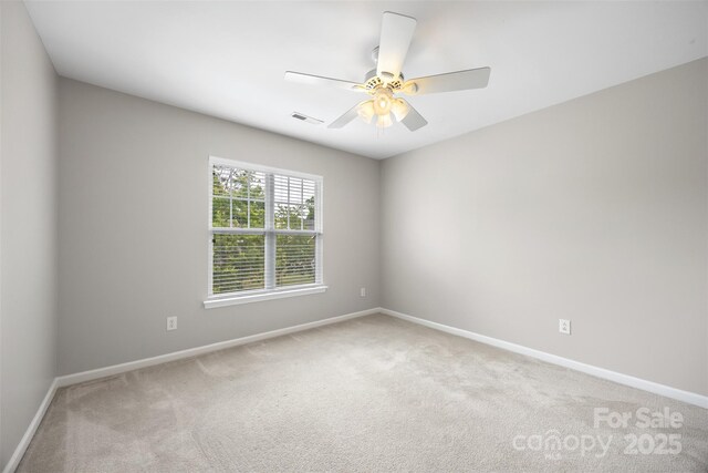 unfurnished room featuring light carpet, baseboards, and ceiling fan