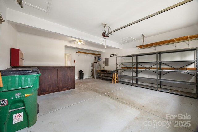 garage with gas water heater and a garage door opener