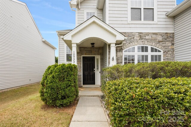 entrance to property featuring stone siding