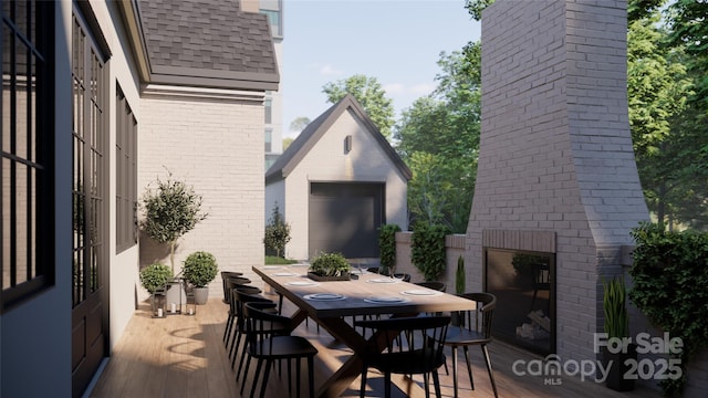 view of patio / terrace featuring outdoor dining space and a fireplace