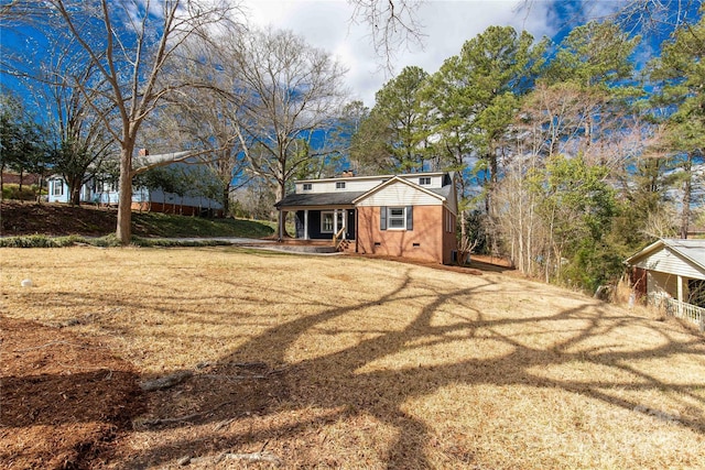 exterior space with driveway, a porch, crawl space, and a front lawn