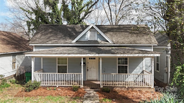view of front facade featuring covered porch and roof with shingles