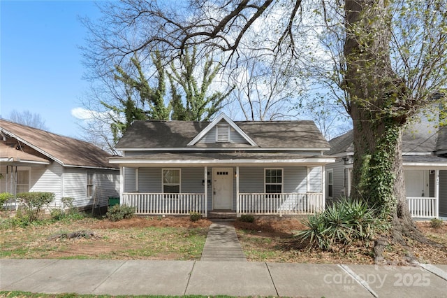 view of front of house featuring roof with shingles and covered porch