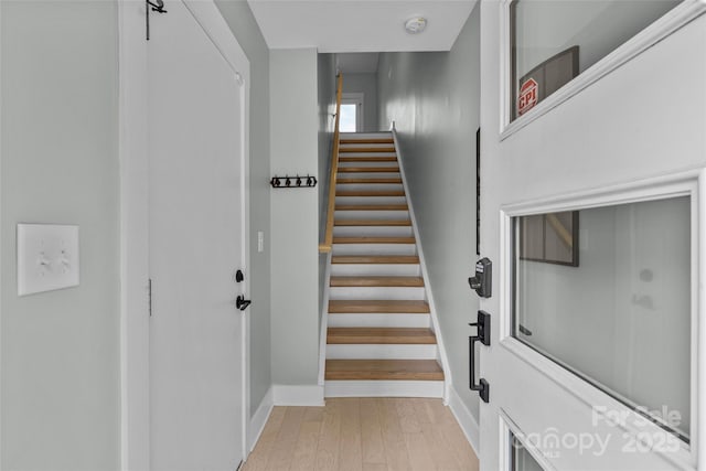 stairs with baseboards and wood finished floors