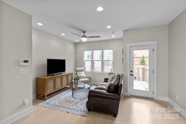 living area featuring recessed lighting, a ceiling fan, baseboards, and wood finished floors