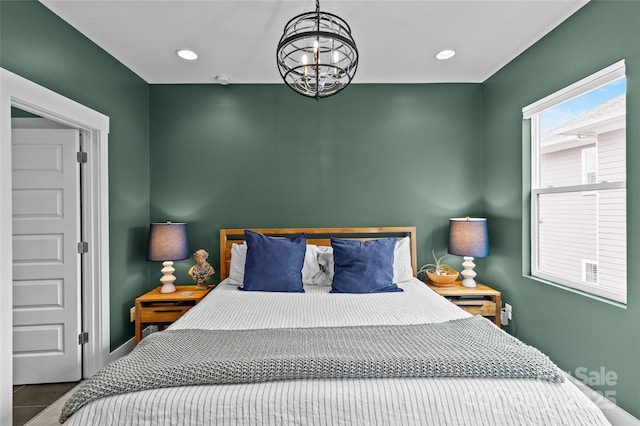 bedroom featuring a notable chandelier, recessed lighting, and baseboards