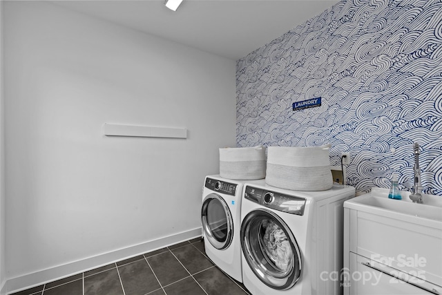 washroom with laundry area, independent washer and dryer, baseboards, and dark tile patterned flooring