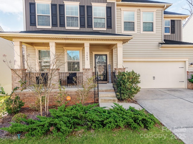 view of front of house with a garage, a porch, board and batten siding, and concrete driveway