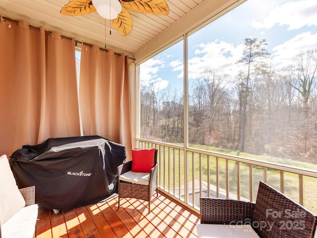 sunroom featuring wooden ceiling and ceiling fan