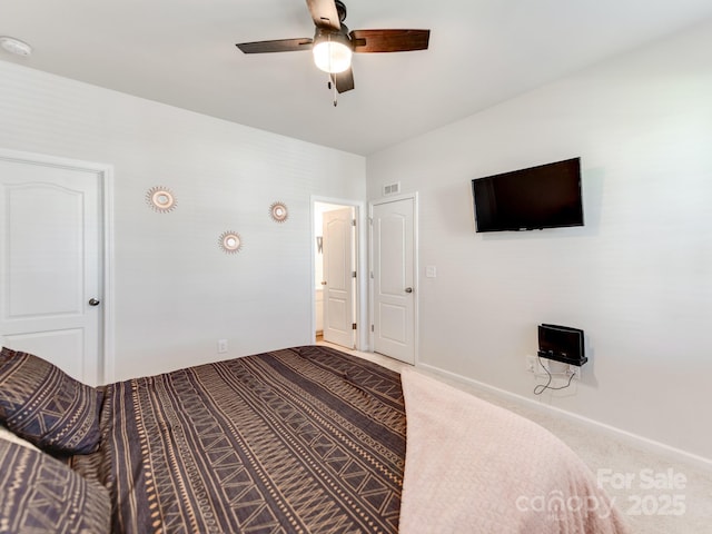 carpeted bedroom with baseboards, visible vents, and a ceiling fan