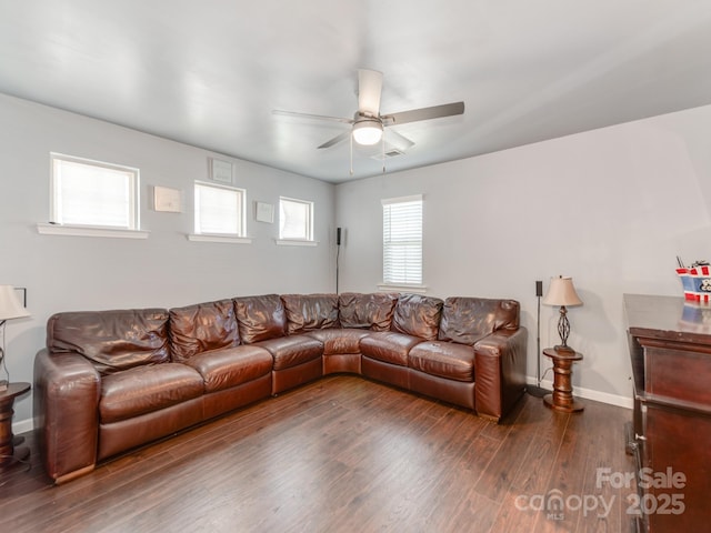 living area with ceiling fan, dark wood-type flooring, and baseboards