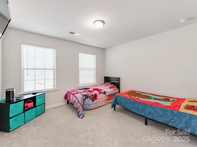 carpeted bedroom featuring baseboards and visible vents