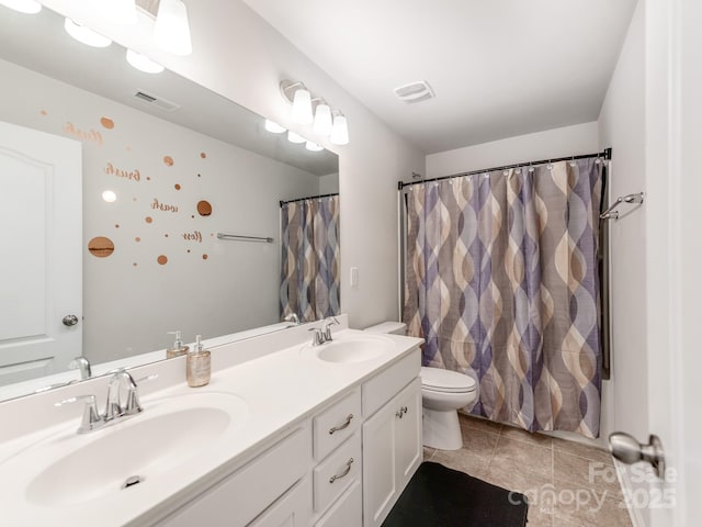 full bath featuring double vanity, visible vents, and a sink