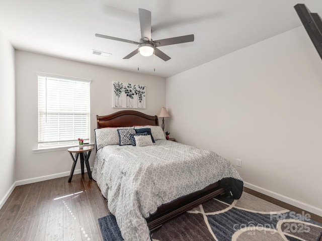 bedroom with visible vents, ceiling fan, baseboards, and wood finished floors