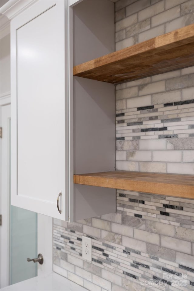 interior details with tasteful backsplash and white cabinets