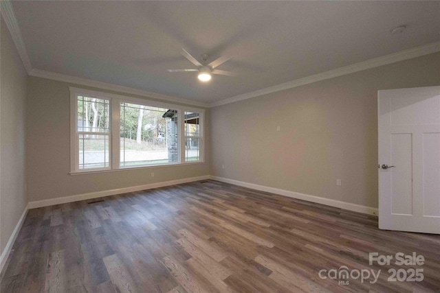 spare room featuring a ceiling fan, baseboards, ornamental molding, and dark wood-type flooring