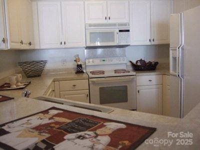 kitchen with white cabinets and white appliances