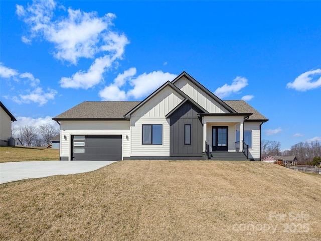 modern farmhouse with an attached garage, driveway, roof with shingles, a front lawn, and board and batten siding