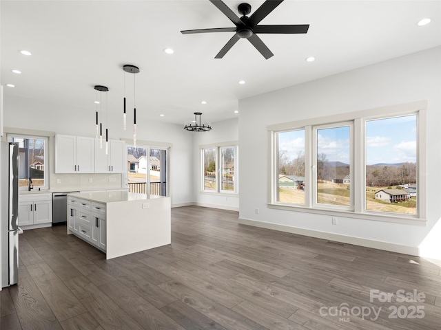 kitchen with a center island, dark wood-style flooring, recessed lighting, light countertops, and appliances with stainless steel finishes