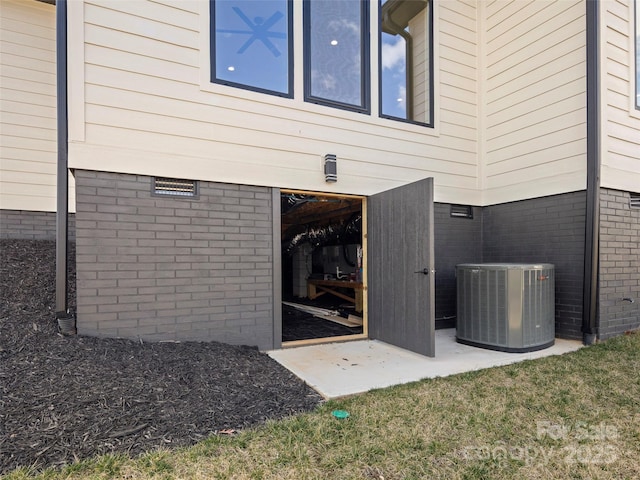 entrance to property with cooling unit and crawl space