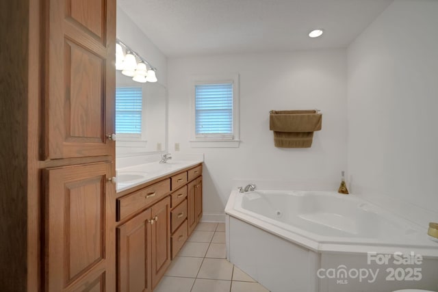 full bath featuring double vanity, tile patterned flooring, a sink, and a whirlpool tub