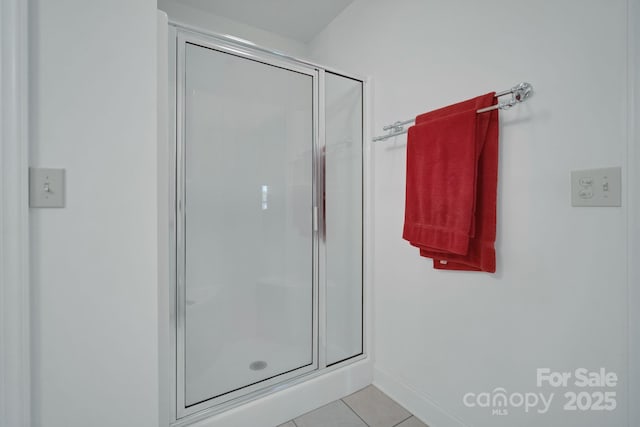 full bathroom featuring baseboards, a shower stall, and tile patterned floors