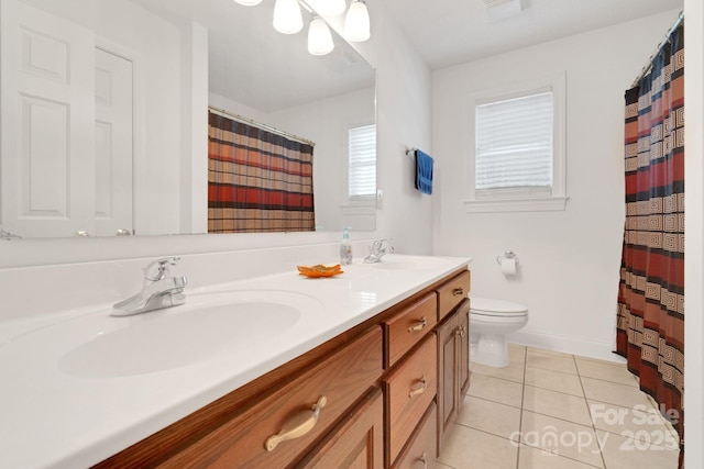 full bath with double vanity, a sink, toilet, and tile patterned floors