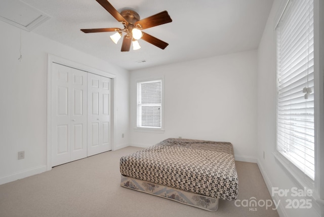 bedroom featuring a closet, carpet, and baseboards