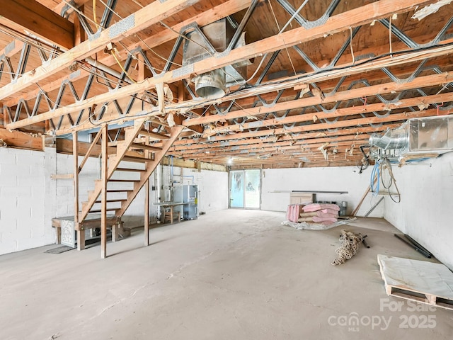 below grade area featuring stairway and water heater