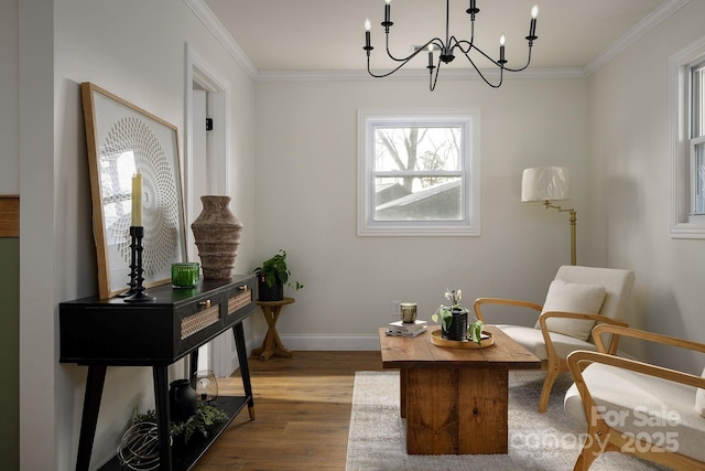 sitting room featuring ornamental molding, wood finished floors, and baseboards