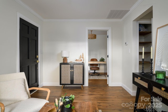 living area featuring baseboards, crown molding, visible vents, and wood finished floors